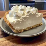 A creamy slice of No-Bake Marshmallow Whip Cheesecake is served as one of the easiest Easy Desserts For Christmas on a festive dessert plate.