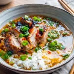 Glossy, seared Caramelized Soy Chicken in a bowl of broth, a comforting choice among chicken dinner recipes.