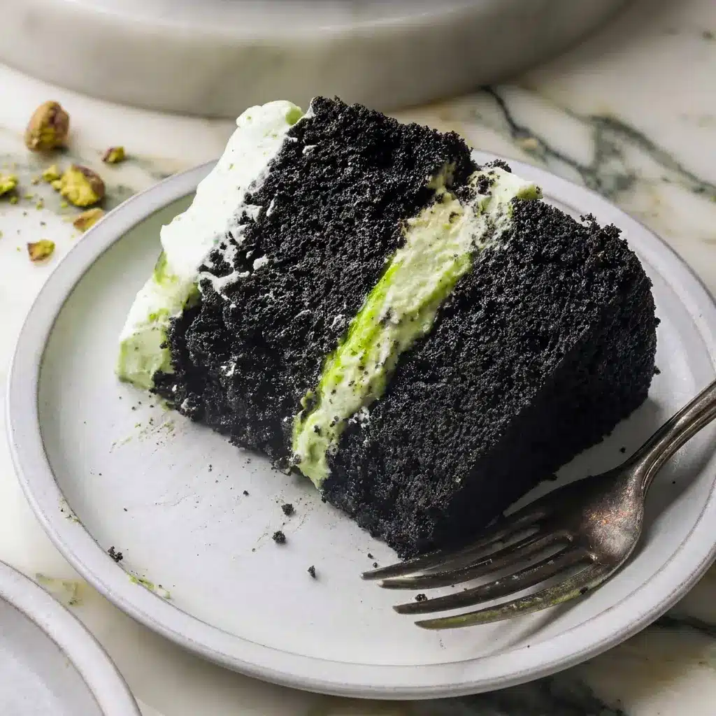 Piped swirls of frosting on Chocolate Pistachio Cake, styled as a chocolate cake with pistachio frosting for any occasion.
