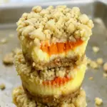 A tray of golden Mini Pumpkin Cheesecake with Streusel Topping, one of the best Fun Thanksgiving Desserts for the holiday table.