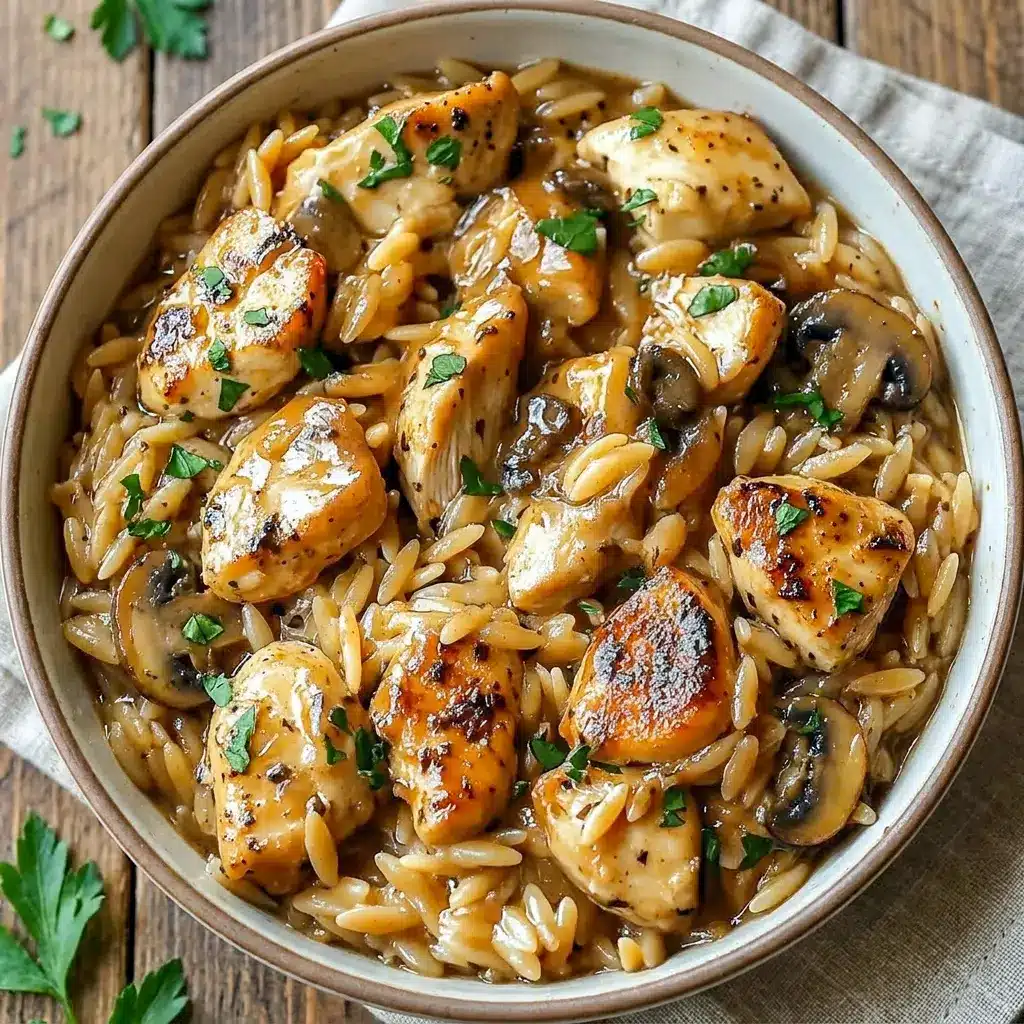 Overhead shot of Chicken Marsala Orzo in a Dutch oven topped with parsley, a hearty Chicken Marsala Orzo Skillet meal.